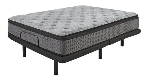 A mattress with an adjustable base on top of it.