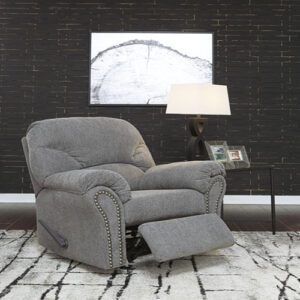 A gray recliner sitting in front of a wall.