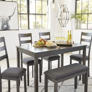 A dining room table with four chairs and a bench.