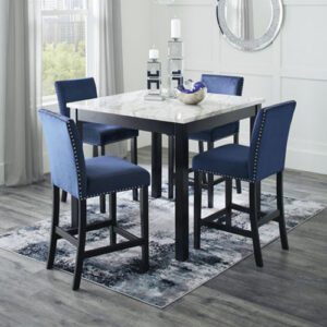 A dining room table with blue chairs and a rug