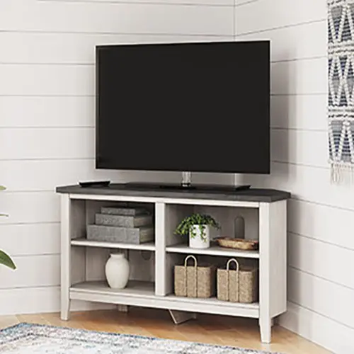A tv stand with a television and some baskets