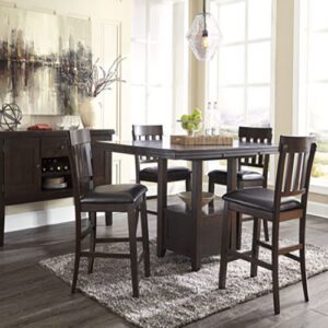 A dining room table with four chairs and a buffet.
