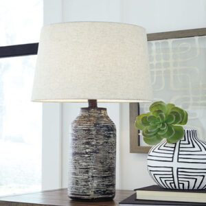 A table lamp sitting on top of a wooden table.
