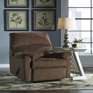 A brown recliner sitting in front of two windows.