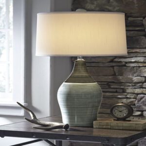 A table lamp sitting on top of a wooden table.