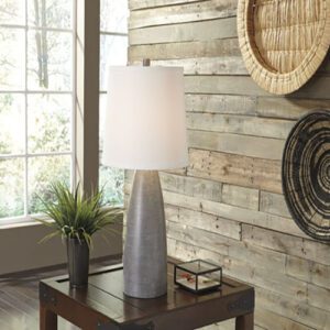 A table lamp sitting on top of a wooden table.
