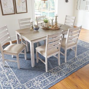 A dining room table with six chairs and a rug.