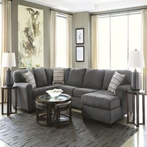 A living room with grey furniture and a large window.