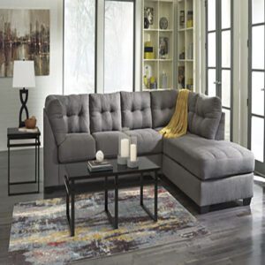 A living room with grey furniture and a table