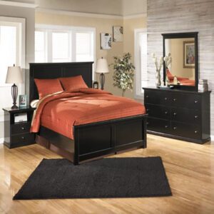 A bedroom with black furniture and red sheets.
