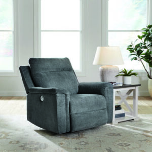 A chair in the middle of a room with a table.