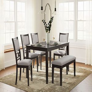 A dining room table with four chairs and two benches.