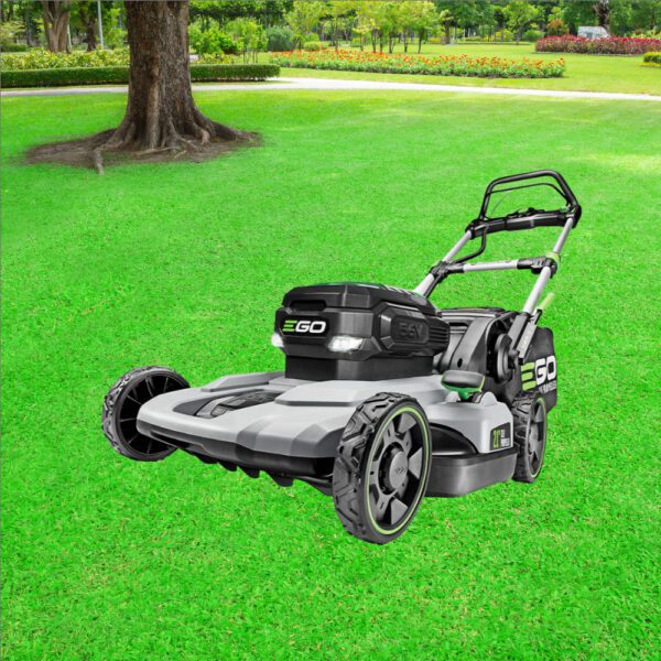 A lawn mower sitting in the middle of a green field.