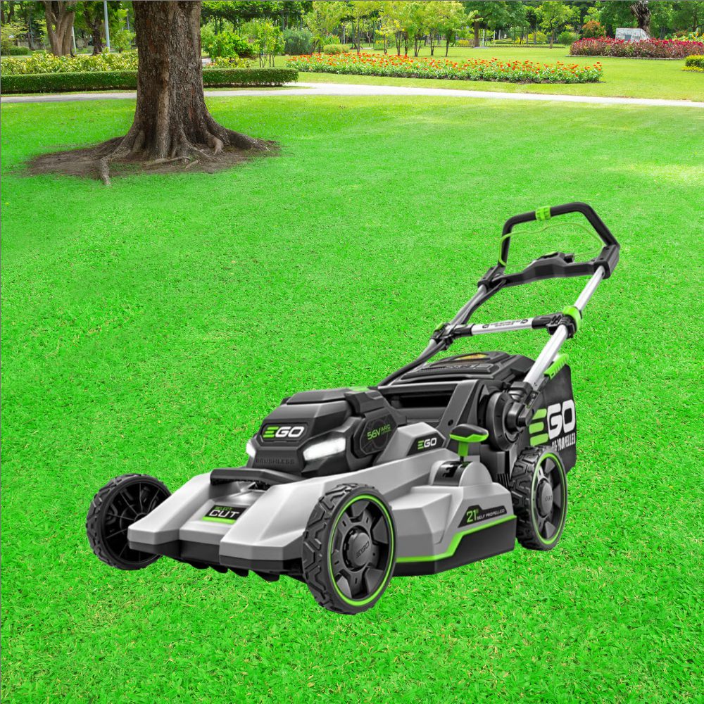 A lawn mower sitting in the middle of a green field.